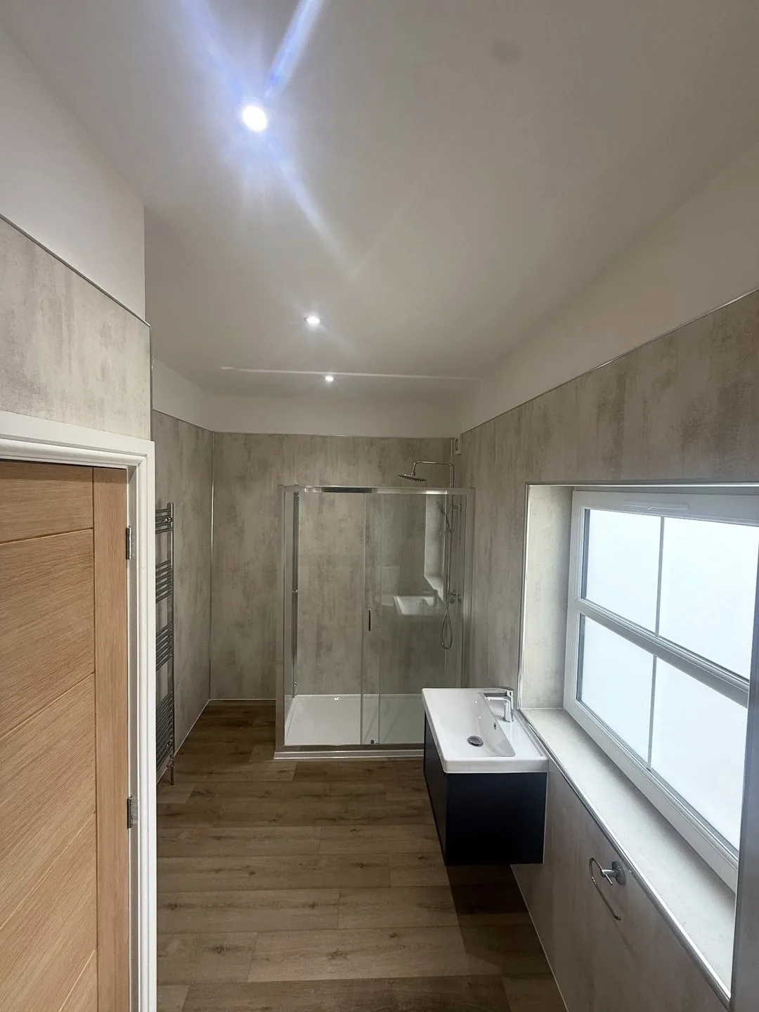 Finished bathroom with walk-in shower and recessed ceiling lights