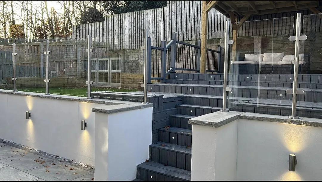 Completed raised decking with wall and step lighting in daylight