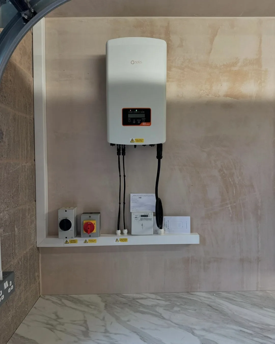 Solar PV inverter and isolation installed in a garage in Cumbria